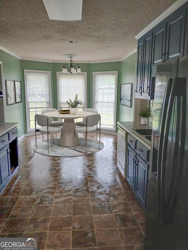 dining area featuring crown molding, a textured ceiling, and a chandelier