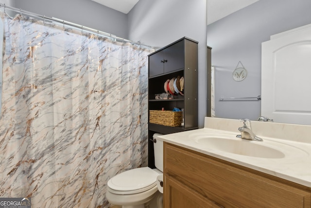 bathroom featuring vanity, a shower with curtain, and toilet
