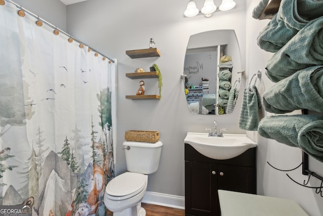 bathroom featuring vanity, wood finished floors, toilet, baseboards, and a shower with curtain