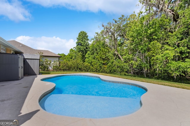 view of swimming pool with a fenced in pool, fence, and a patio