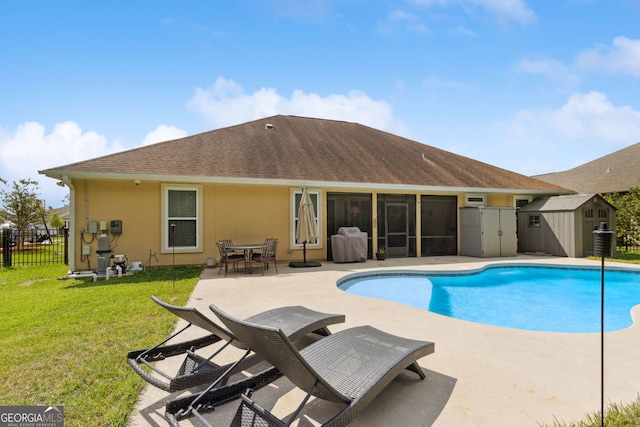 view of pool featuring fence, a storage unit, a sunroom, a patio area, and an outbuilding