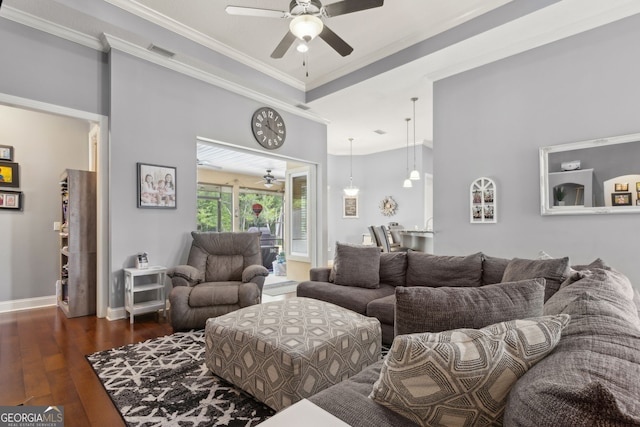 living area featuring visible vents, crown molding, hardwood / wood-style floors, baseboards, and ceiling fan