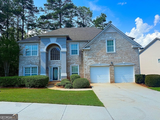 traditional-style home with a garage, driveway, and a front lawn