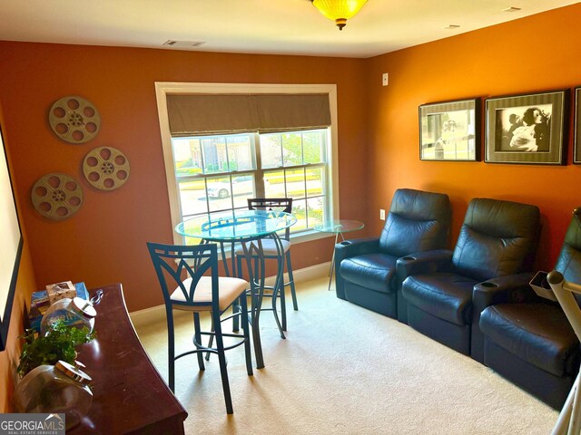 living room featuring carpet floors, baseboards, and visible vents