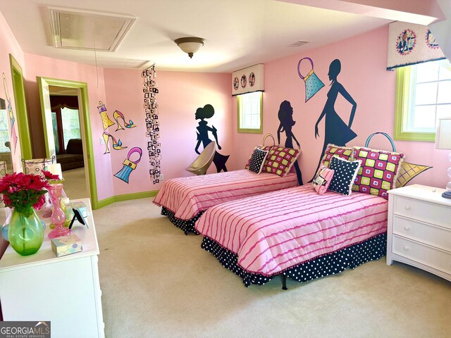 bedroom with baseboards, carpet, and attic access