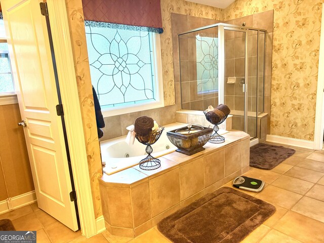 bathroom with tile patterned floors, plenty of natural light, and a stall shower