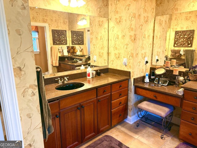 bathroom with a sink, tile patterned floors, and wallpapered walls