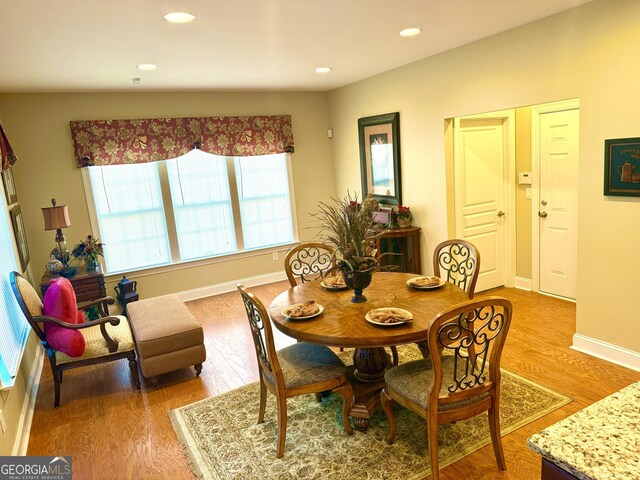 dining room with recessed lighting, baseboards, and light wood-type flooring