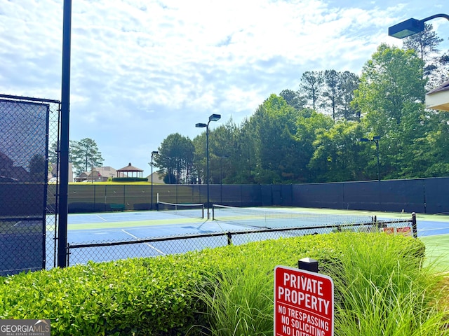 view of sport court featuring fence