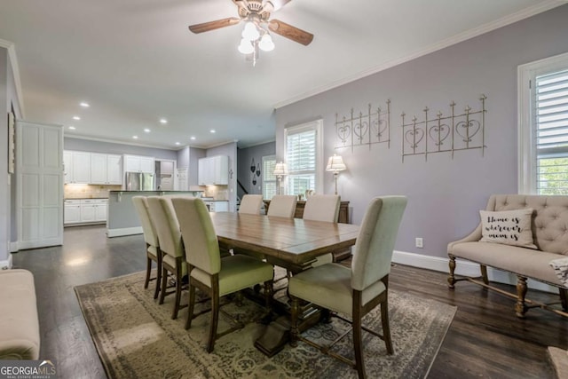 dining area featuring crown molding, baseboards, a ceiling fan, and dark wood-style flooring
