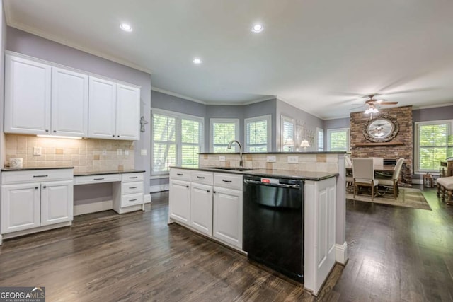 kitchen with ceiling fan, dark countertops, dark wood finished floors, a sink, and black dishwasher