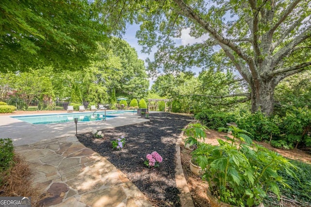 outdoor pool featuring fence