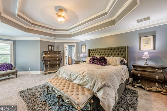 carpeted bedroom with crown molding, a tray ceiling, visible vents, and baseboards