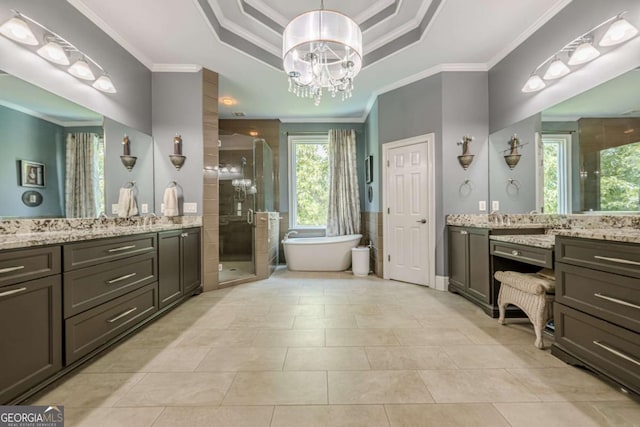 full bathroom featuring crown molding, an inviting chandelier, vanity, a freestanding bath, and a stall shower