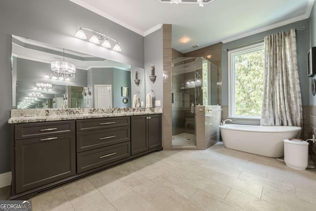 full bath featuring a freestanding bath, vanity, a chandelier, a shower stall, and ornamental molding