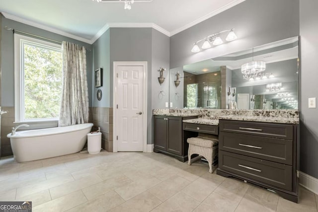 full bath featuring crown molding, an inviting chandelier, vanity, a soaking tub, and a stall shower