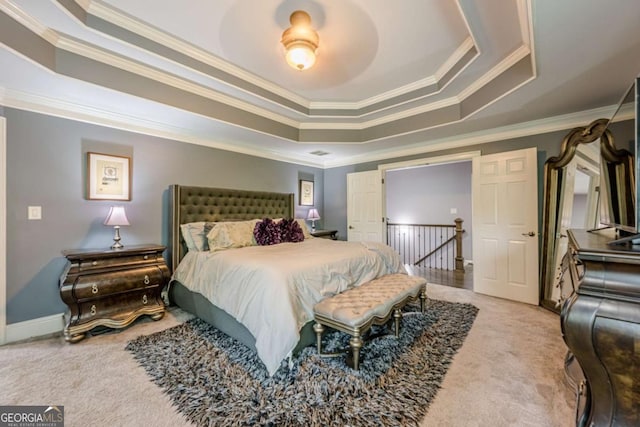 bedroom featuring crown molding, a raised ceiling, and carpet