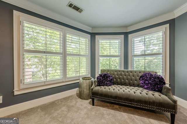 living area with visible vents, ornamental molding, carpet, and baseboards