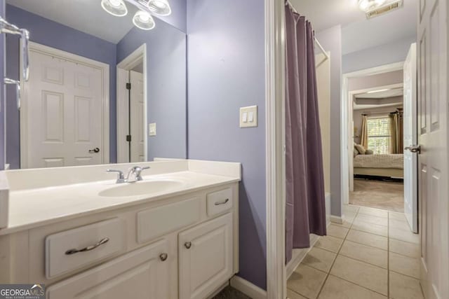 full bath with visible vents, vanity, baseboards, ensuite bathroom, and tile patterned floors