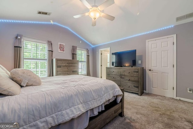 carpeted bedroom with visible vents, ceiling fan, and lofted ceiling