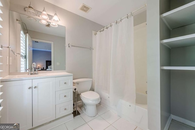 full bathroom with visible vents, vanity, toilet, tile patterned floors, and shower / bath combo
