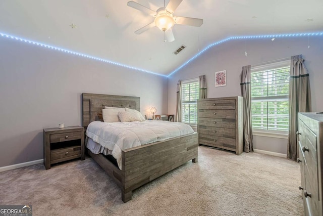 bedroom with visible vents, baseboards, lofted ceiling, and light colored carpet