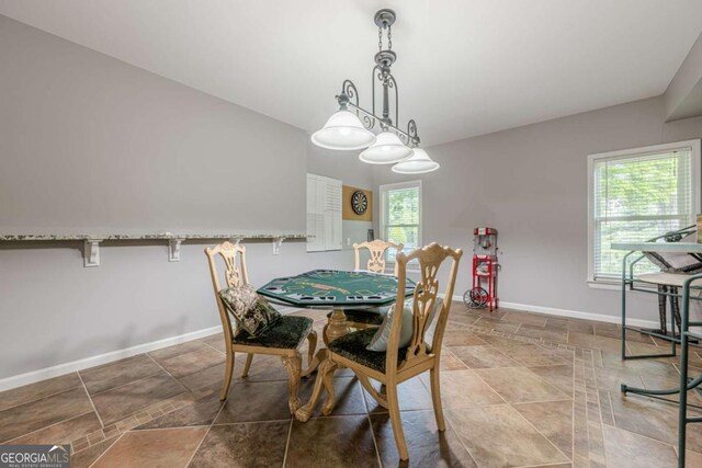 dining room with baseboards and stone finish flooring