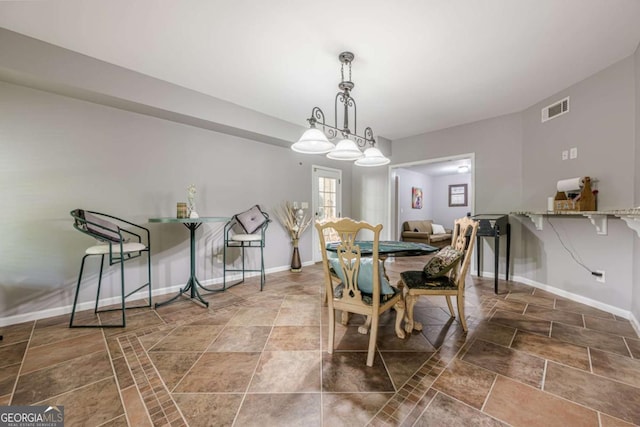 dining room with stone finish flooring, baseboards, and visible vents