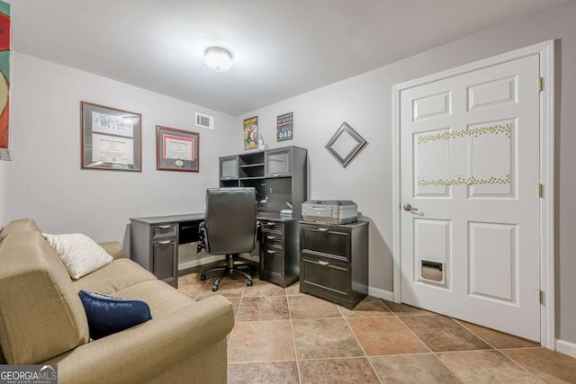 office space featuring baseboards and visible vents