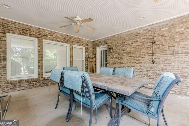 dining room with brick wall and ceiling fan