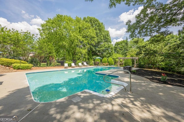 pool featuring fence and a patio area