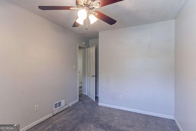 5723 Fieldstone Dr, Lithonia, GA 30038 - spare room featuring baseboards, a ceiling fan, visible vents, and dark carpet