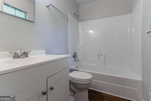 5723 Fieldstone Dr, Lithonia, GA 30038 - bathroom featuring vanity, bathing tub / shower combination, toilet, and wood finished floors