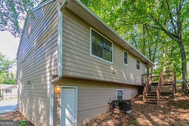 5723 Fieldstone Dr, Lithonia, GA 30038 - view of property exterior featuring stairway, a wooden deck, and central AC unit