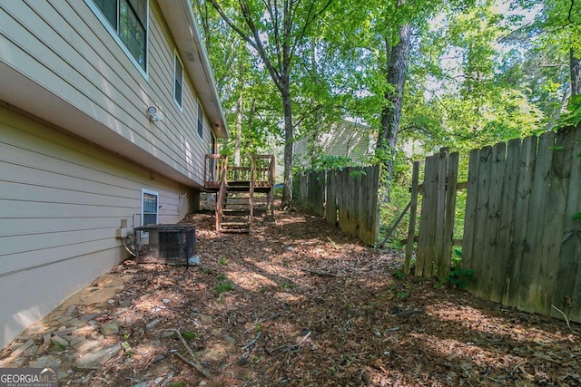 5723 Fieldstone Dr, Lithonia, GA 30038 - view of yard featuring central air condition unit, fence, and a wooden deck