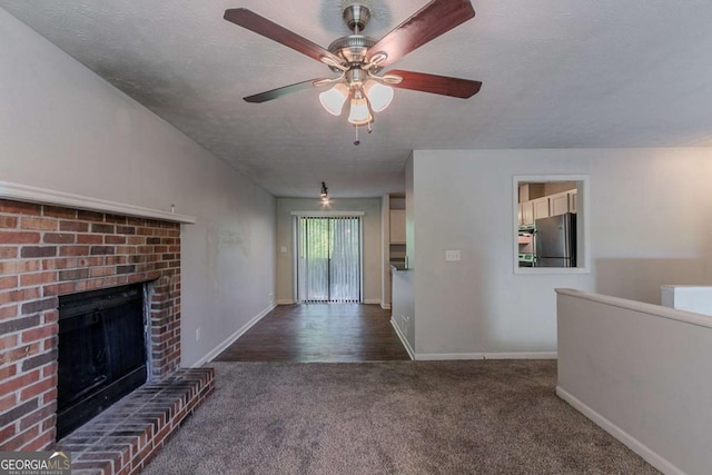 5723 Fieldstone Dr, Lithonia, GA 30038 - unfurnished living room featuring ceiling fan, a brick fireplace, carpet floors, and baseboards