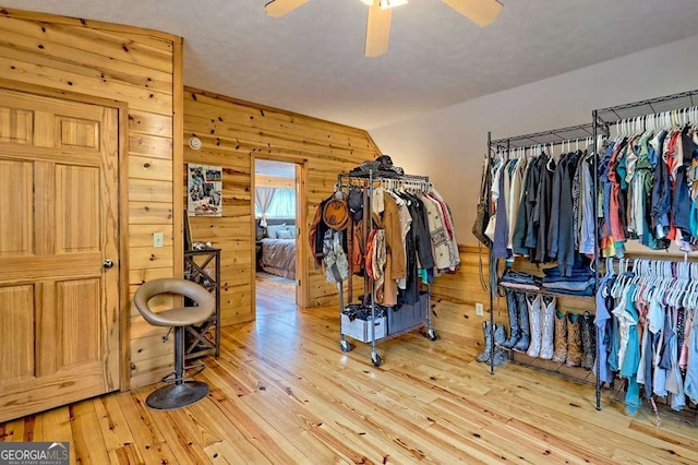 spacious closet with a ceiling fan and hardwood / wood-style flooring
