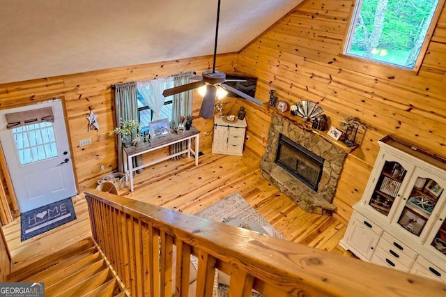 428 Gibbs Rd, Blairsville, GA 30512 - living area with wood walls, hardwood / wood-style flooring, a fireplace, ceiling fan, and lofted ceiling