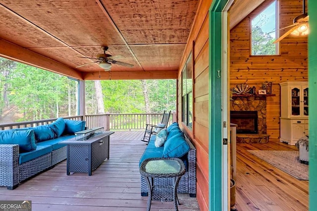 deck featuring an outdoor living space and ceiling fan