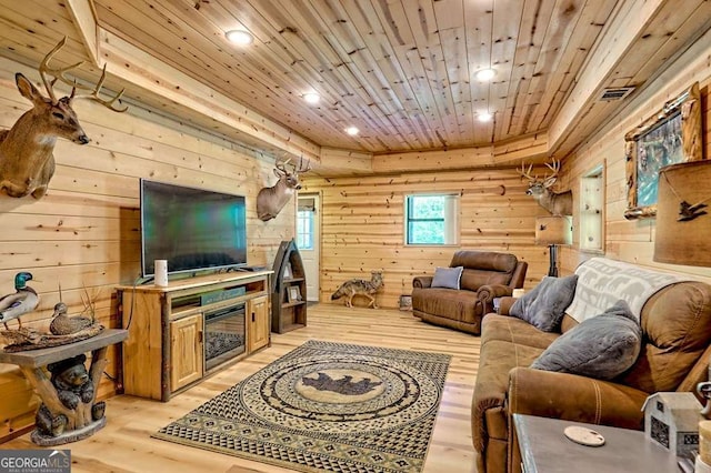 living area featuring wood walls, recessed lighting, wood ceiling, a tray ceiling, and light wood finished floors