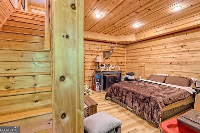 bedroom with recessed lighting, wood walls, wood ceiling, and light wood finished floors