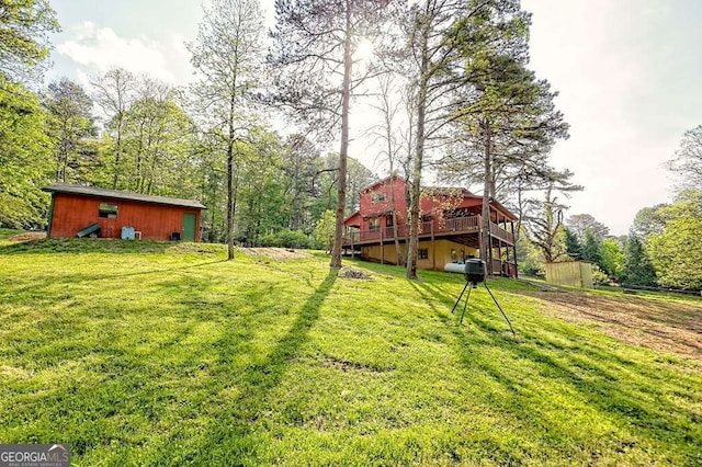 view of yard featuring an outbuilding and a deck