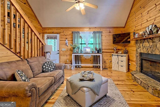 428 Gibbs Rd, Blairsville, GA 30512 - living area with lofted ceiling, hardwood / wood-style floors, wooden walls, ceiling fan, and a fireplace