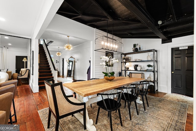 dining space featuring stairs, a chandelier, and hardwood / wood-style floors