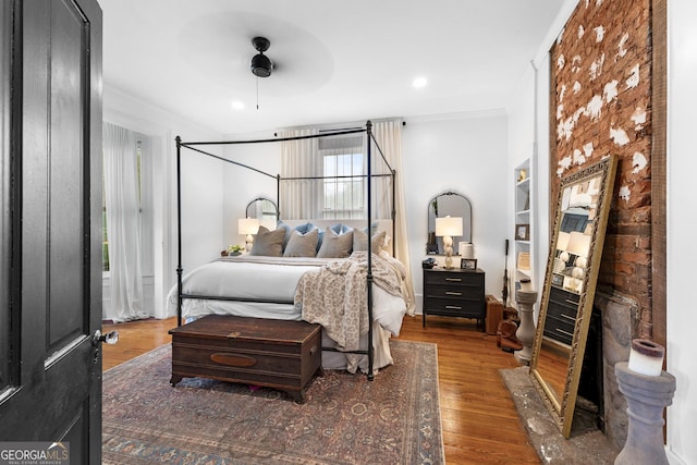 bedroom with ornamental molding, recessed lighting, and wood finished floors