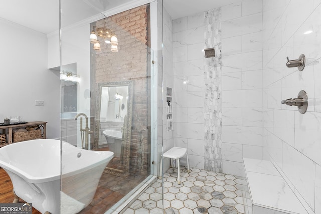 full bathroom with tile patterned floors, a soaking tub, a tile shower, and a chandelier