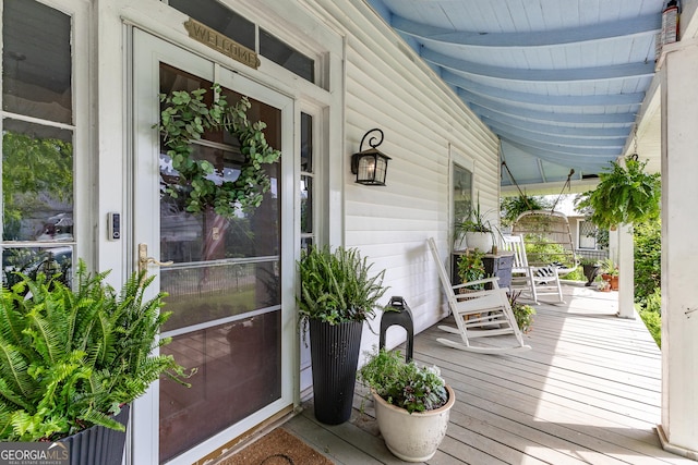 view of exterior entry with a porch