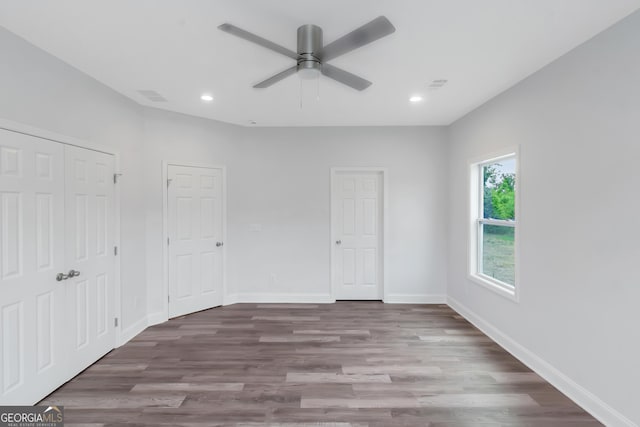 unfurnished bedroom with wood finished floors, recessed lighting, baseboards, and a ceiling fan