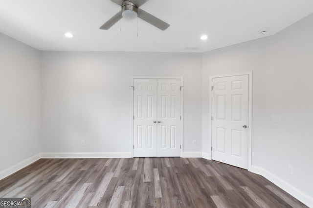 unfurnished bedroom with wood finished floors, baseboards, recessed lighting, a closet, and a ceiling fan