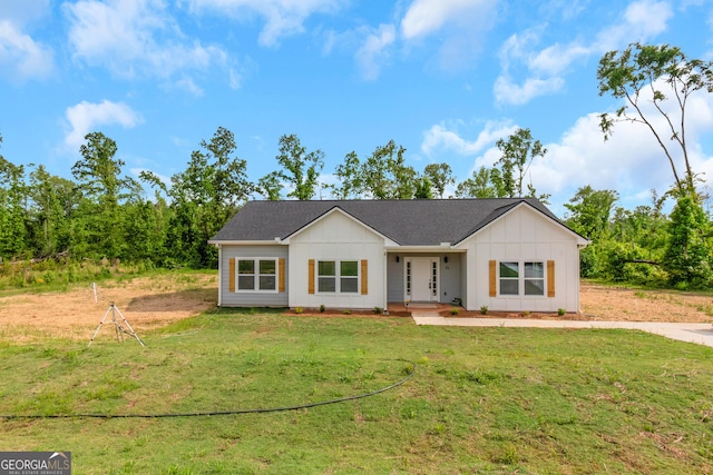 view of front facade featuring board and batten siding and a front yard